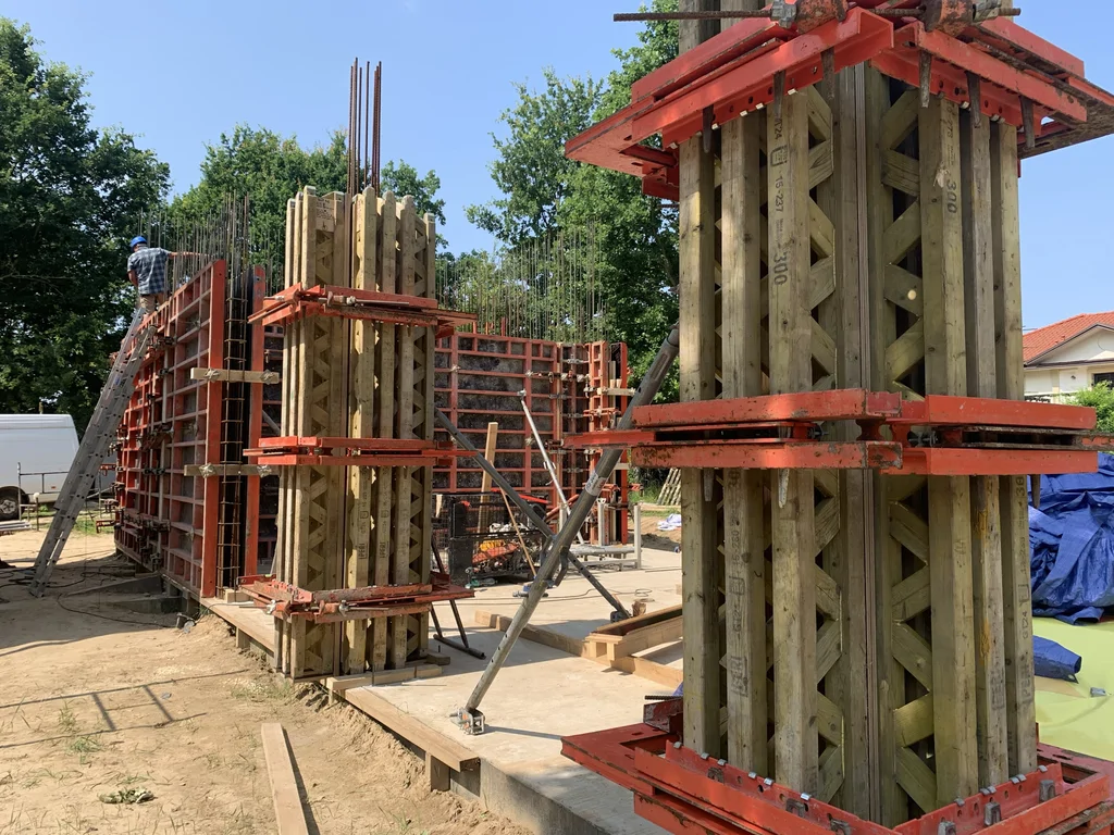 Szalunki słupów i ścian żelbetowych na budowie – etap prac pod beton architektoniczny