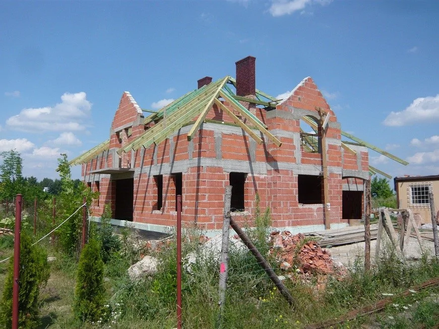 Budowa domu jednorodzinnego, stan surowy, mury, więźba dachowa i kominy